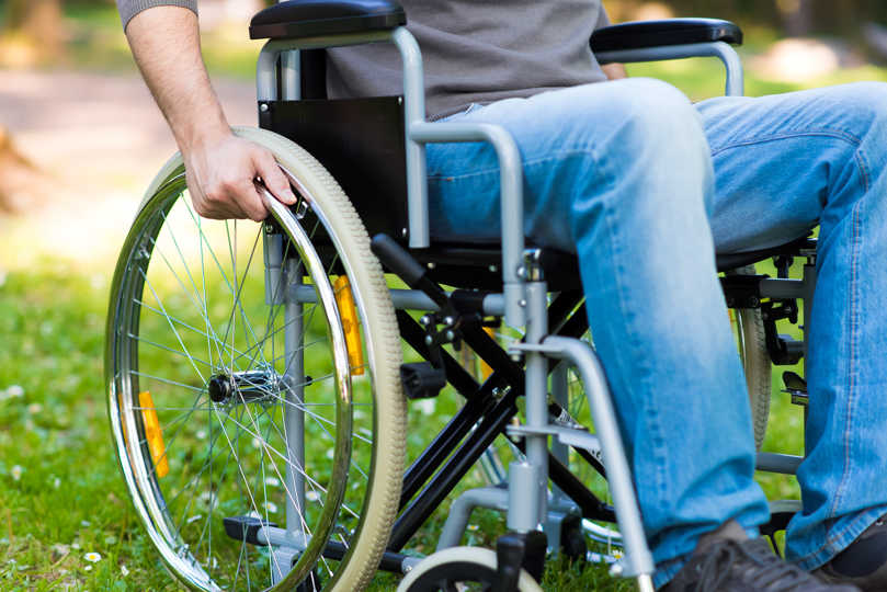 A photograph of a person in a wheelchair.