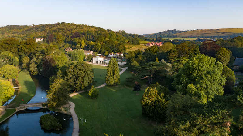 Photograph from high above of Kearsney Abbey park, showing the River Dour, the Cedar of Lebanon tree and the new Cafe.