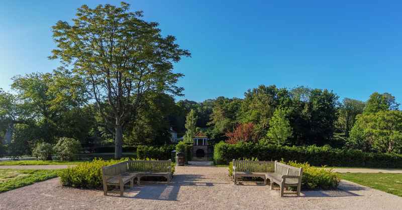 Photograph looking towards the benches and Boat House, at Russell Gardens.