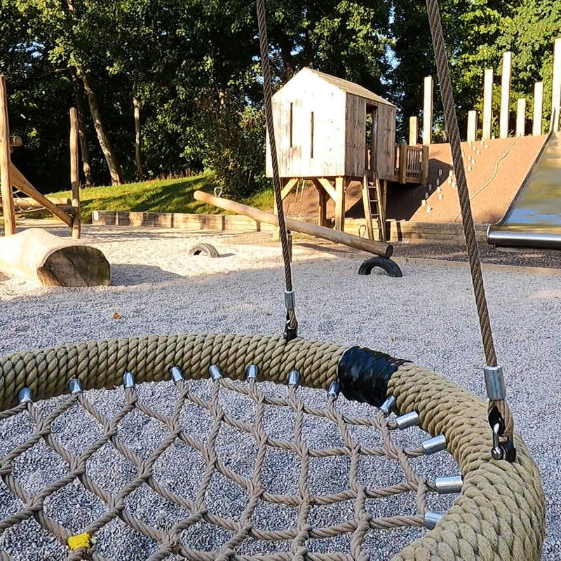 A photograph of the netted-seat swing, in the Natural Play Area at Russell Gardens.