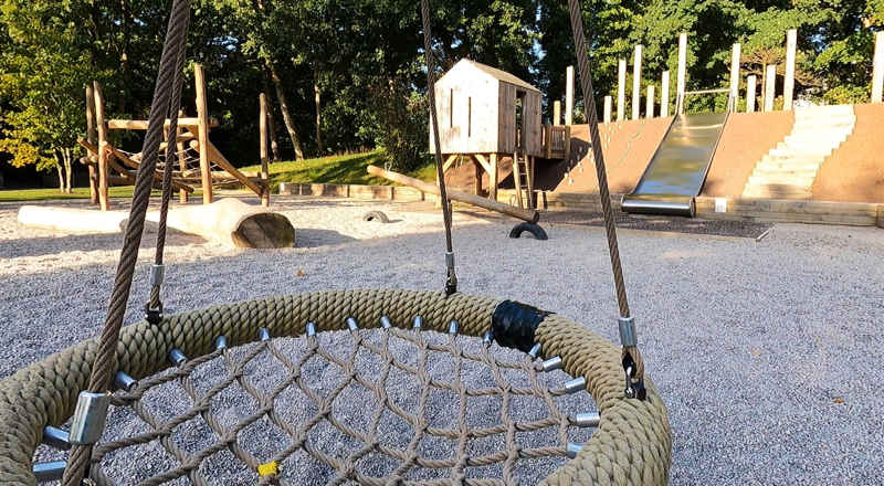A photograph of the netted-seat swing, in the Natural Play Area at Russell Gardens.